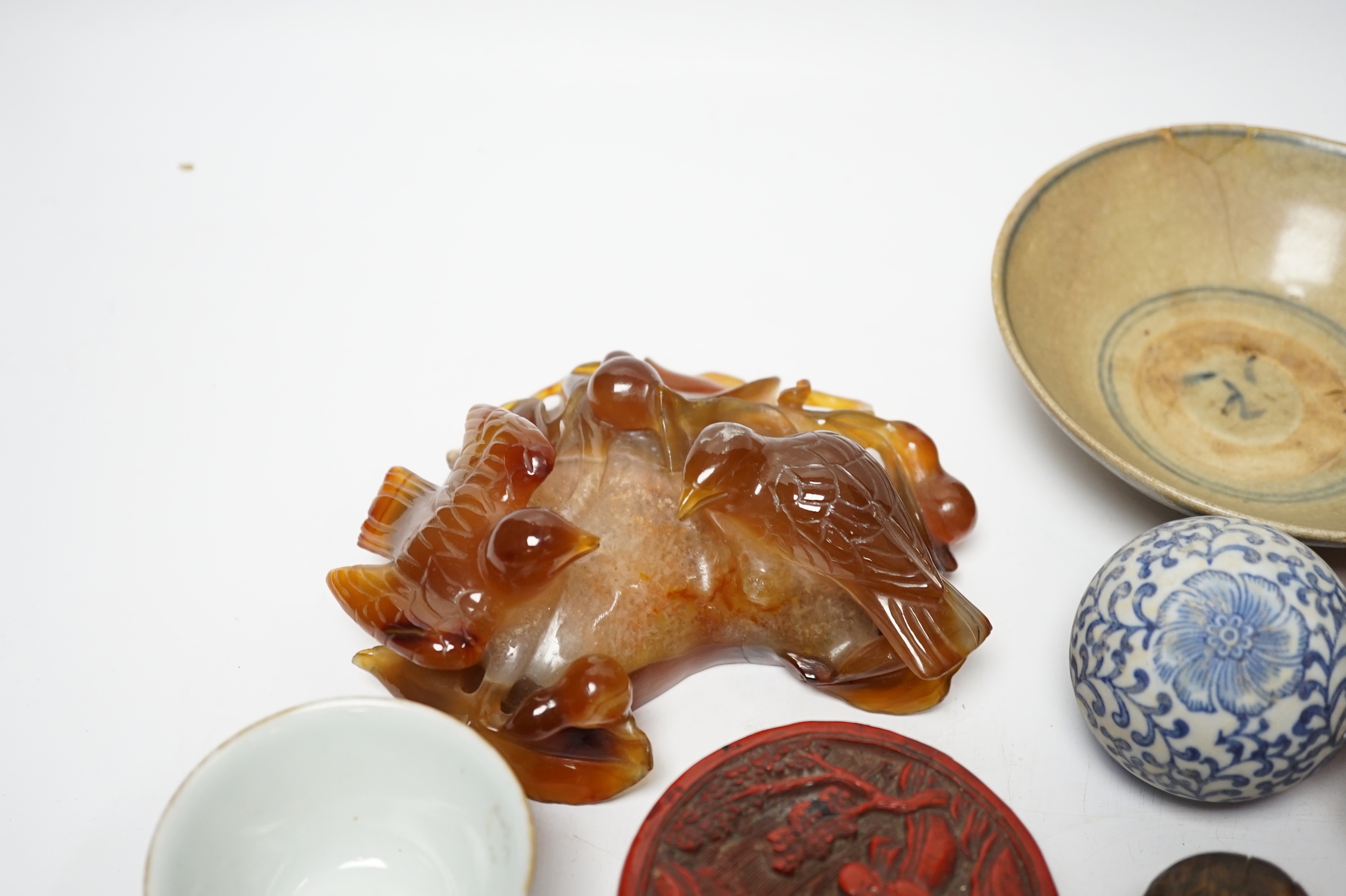 Eleven Chinese or Japanese items including; a bowl, a red lacquer box, an agate carving of a bird group, a carved hardstone lion tortoise, mother of pearl counters, etc.